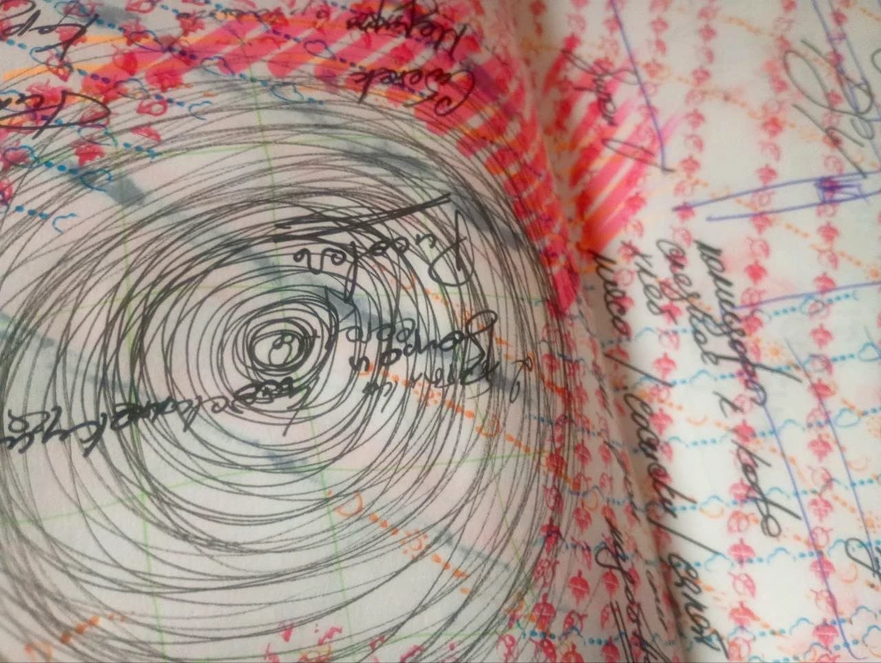 Pencil spiral and multicolour notebook marks.