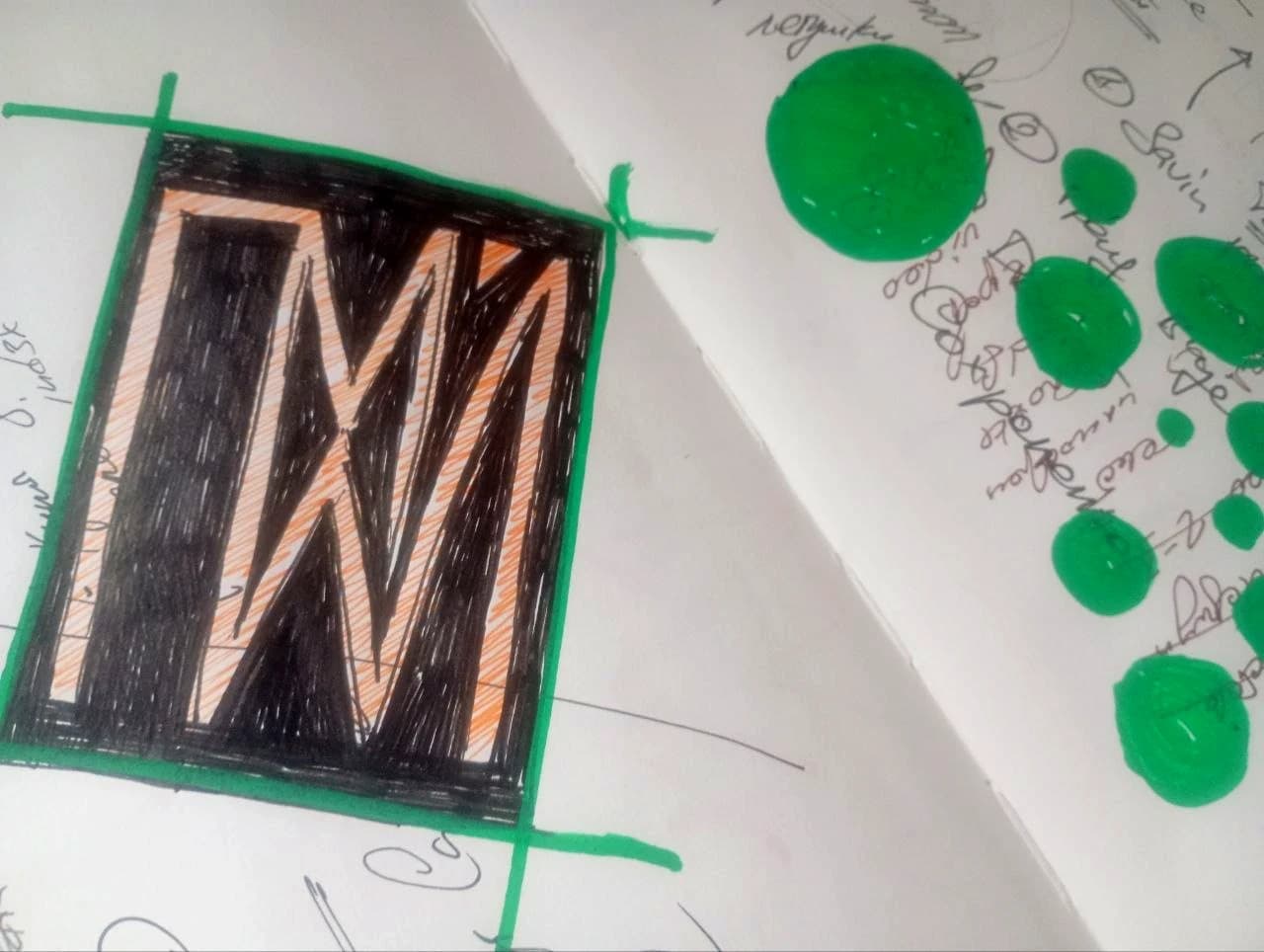 Green circles and a black geometric letterform.