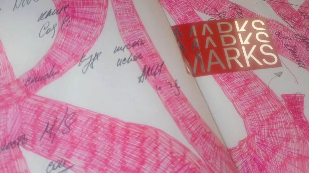 An original sketchbook spread with pink crosshatched loops, a red MARKS label and overlapping handwritten notes.