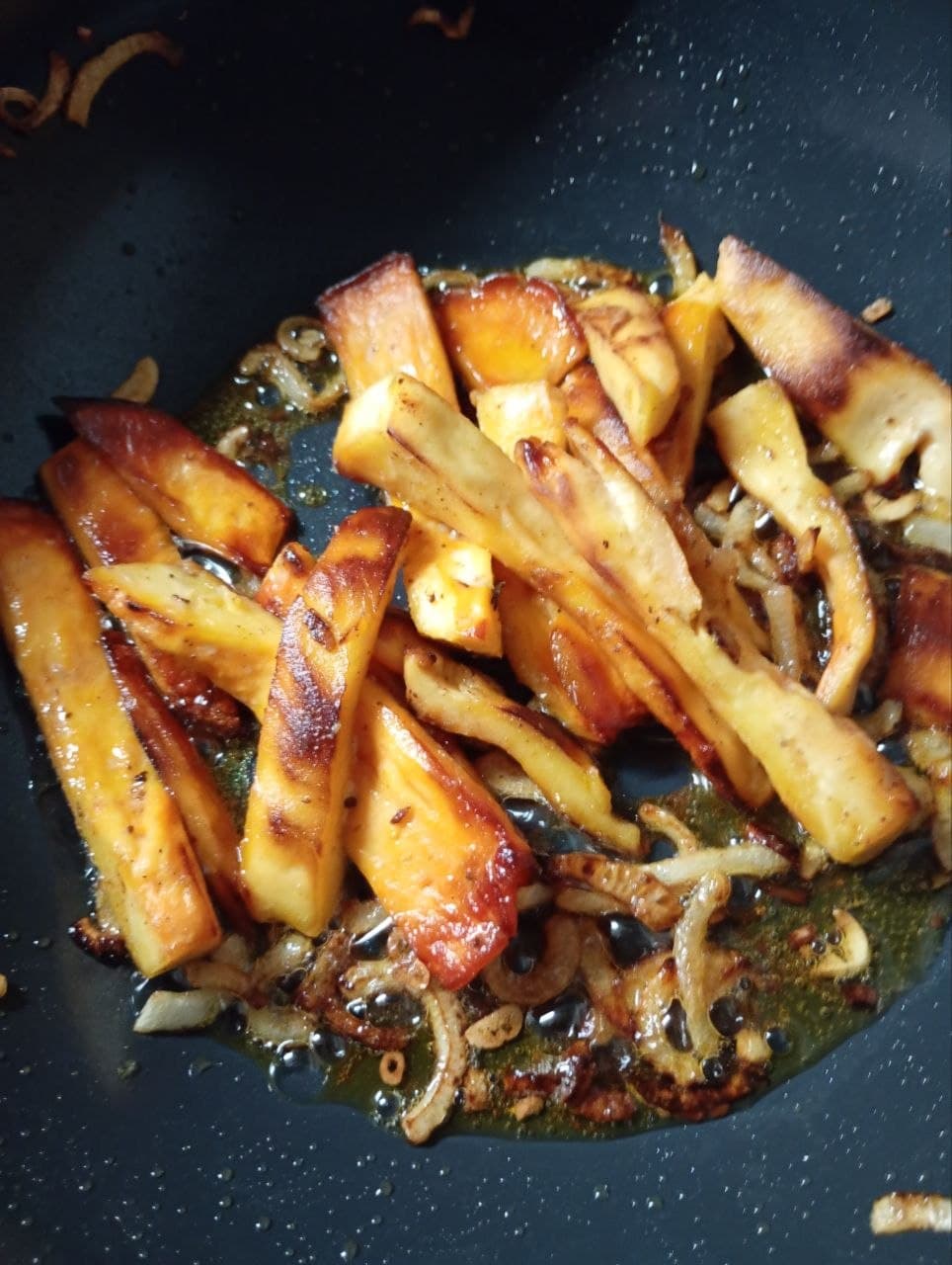 Browned strips in a frying pan with butter, onions, garlic and mustard.