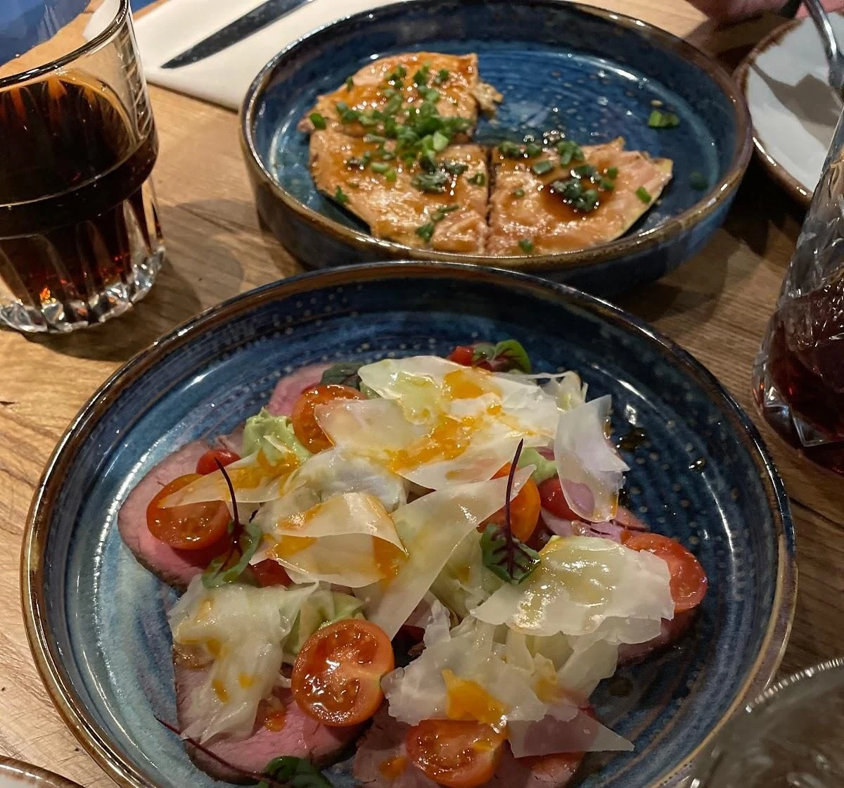 Dishes served at Gastronom, photographed on blue plates.